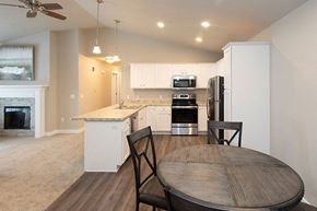 Sister Bay apartment for rent - A kitchen with a table and chairs in the foreground.