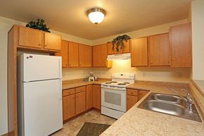 Ripon apartment for rent - a kitchen with a stove refrigerator and a sink