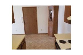 Wisconsin Rapids apartment for rent - an empty kitchen with a stove and a door