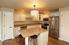 Oconomowoc apartment for rent - A kitchen with a granite countertop and stainless steel appliances.