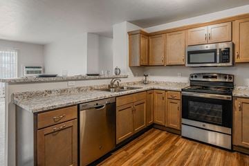 Plover apartment for rent - A kitchen with wooden cabinets and stainless steel appliances.