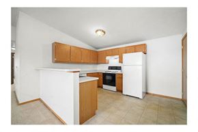 Marshfield apartment for rent - a kitchen with white appliances and wooden cabinets