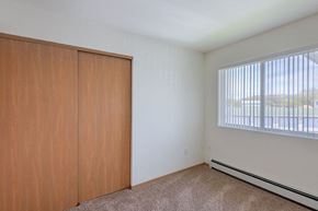 Columbus apartment for rent - an empty bedroom with a window and a wooden closet