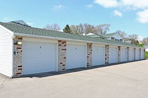 Beaver Dam apartment for rent - a row of white garage doors on the side of a building
