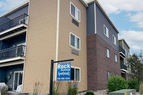 Viroqua apartment for rent - A sign for Rock Avenue Apartments is in front of a building.