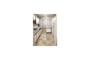 Kasson apartment for rent - a kitchen with white cabinets and counters and a sink