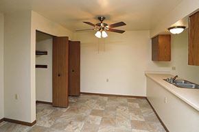 Manitowoc apartment for rent - A room with a tile floor and a ceiling fan.