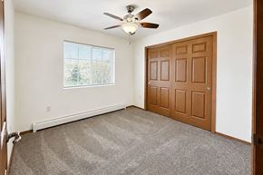 Marshfield apartment for rent - A room with a ceiling fan and a brown door.