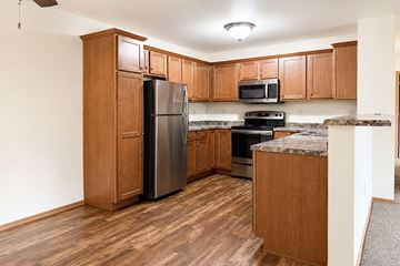 Marshfield apartment for rent - A kitchen with wooden cabinets and a granite countertop.