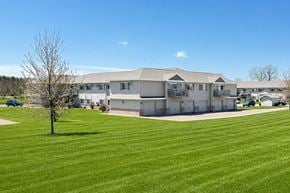 Marshfield apartment for rent - A large building with a green lawn in front of it.