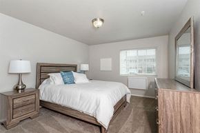 Marshfield apartment for rent - A bedroom with a bed, nightstand, and lamp.