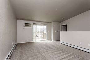 Marshfield apartment for rent - A spacious room with a carpeted floor and a window letting in natural light.