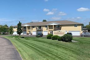 Stevens Point apartment for rent - a large yellow house with a lawn in front of it