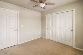 Plover apartment for rent - A room with a ceiling fan and two doors.