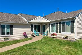 Stewartville apartment for rent - a house with a walkway and lawn in front of it