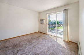 Newton apartment for rent - A room with a carpeted floor and a sliding glass door leading to a balcony.