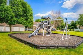 Newton apartment for rent - A playground with a slide and a swing set.