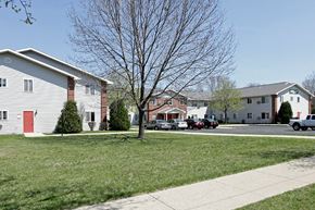 St. Francis apartment for rent - a group of houses with cars parked in the street