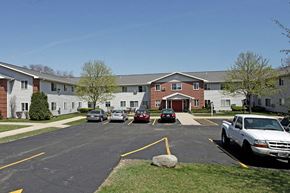 St. Francis apartment for rent - a parking lot with cars in front of an apartment building