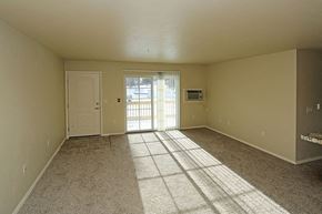 Rhinelander apartment for rent - an empty living room with a door to a balcony