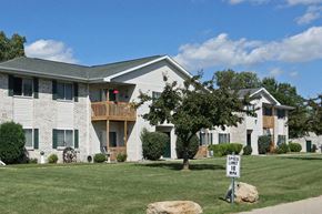 Neenah apartment for rent - a white house with a yard and a street sign