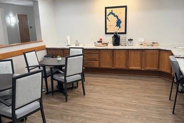 Beaver Dam apartment for rent - A kitchen with a table and chairs and a framed picture of a state on the wall.