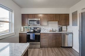South Bend apartment for rent - A kitchen with a stove top oven and a refrigerator.