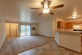 Stevens Point apartment for rent - an empty living room and kitchen with a ceiling fan