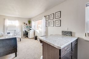 South Bend apartment for rent - A kitchen with a marble countertop and a framed sign that says "Red sleep in the kitchen.".