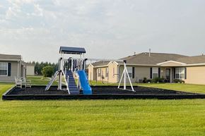 Grand Forks townhouse for rent - a playground with a swing set in front of houses