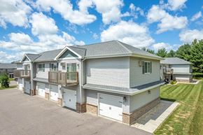 Reedsburg apartment for rent - a row of houses with garages on the side of a street