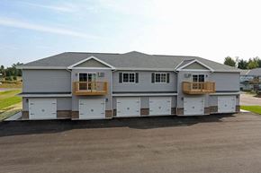 Rhinelander apartment for rent - a house with a garage with white doors