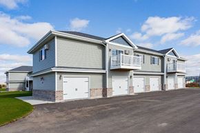 Fox Lake apartment for rent - a blue and white house with white garage doors