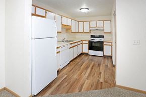 Grand Forks townhouse for rent - an empty kitchen with white appliances and wood floors