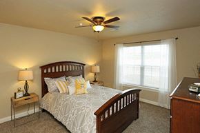 Sister Bay apartment for rent - a bedroom with a bed and a ceiling fan