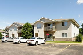 Stevens Point apartment for rent - an apartment building with three cars parked in front of it