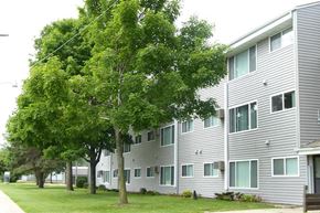 Rochester apartment for rent - a large white building with trees in front of it