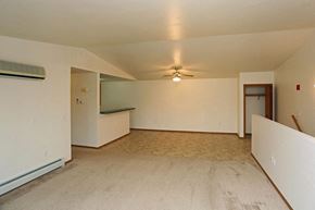 Neenah apartment for rent - an empty living room with white walls and a ceiling fan