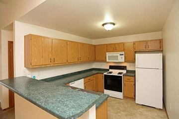 Neenah apartment for rent - a kitchen with a green counter top and white appliances