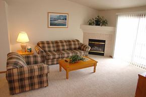Neenah apartment for rent - a living room with two couches and a fireplace