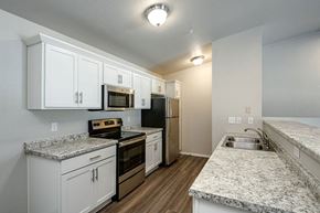 Reedsburg apartment for rent - a kitchen with granite counter tops and white cabinets