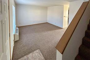 Winfield apartment for rent - an empty living room with white walls and carpet
