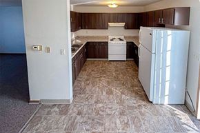 Winfield apartment for rent - an empty kitchen with a refrigerator and a stove