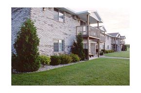 Sturgeon Bay apartment for rent - a brick house with a balcony and a lawn