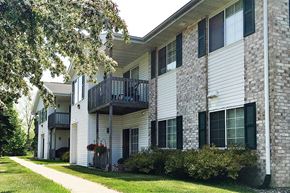 Sturgeon Bay apartment for rent - a brick and white building with a balcony