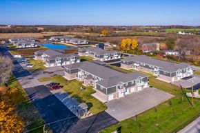Neenah apartment for rent - A large building complex with a pool in the middle.