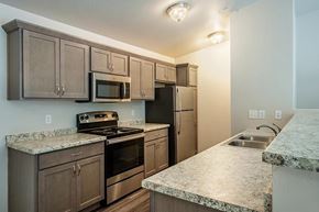 Wisconsin Rapids apartment for rent - A kitchen with granite countertops and stainless steel appliances.