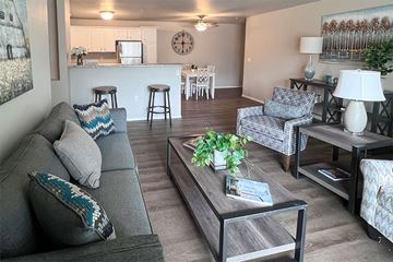 Plover apartment for rent - A living room with a grey couch and a coffee table.