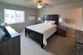 Plover apartment for rent - A bedroom with a large bed and a flat screen TV.