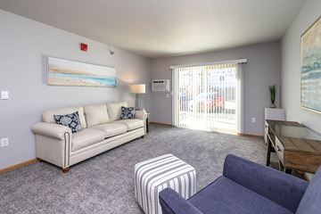 Onalaska apartment for rent - A living room with a couch, chair, and a painting on the wall.